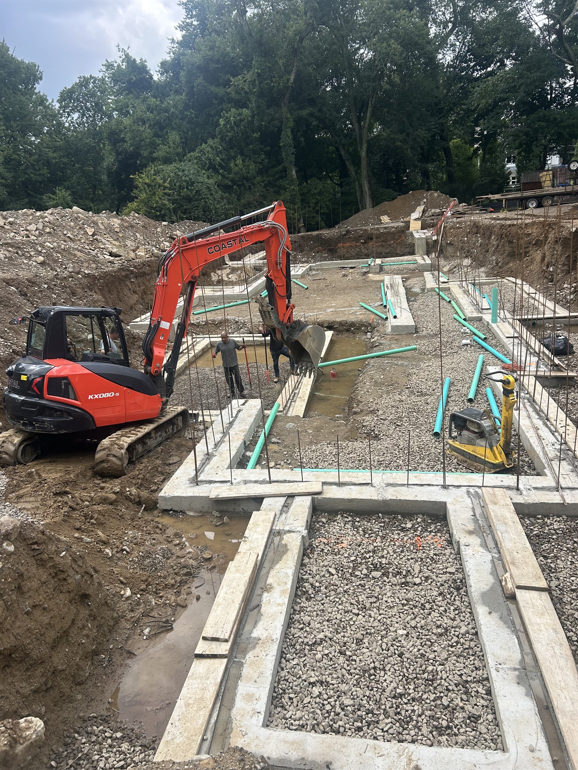 A CLH excavator digging foundation footings on a Connecticut home site